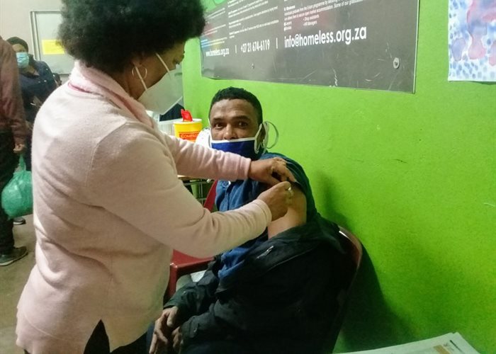 Staff nurse Dinah Boltman gives the Johnson and Johnson vaccine to Ashley Charles at the U-turn Homeless Service Centre in Claremont, Cape Town. | Source: Marecia Damons